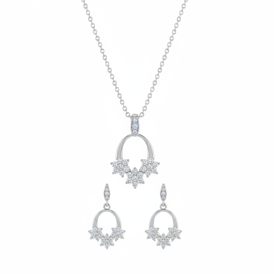 Silver necklace and earrings set on a white background