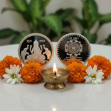 Decorative items with flowers and a lit candle on a white surface