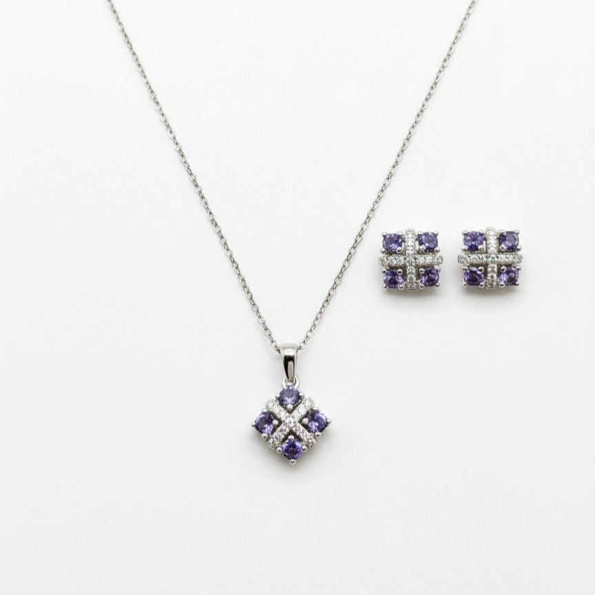 Silver jewelry set with purple gemstones on a white background