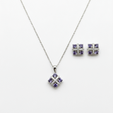 Silver jewelry set with purple gemstones on a white background