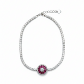 Bracelet with a central red gemstone and diamond-studded border on a white background