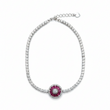 Bracelet with a central red gemstone and diamond-studded border on a white background