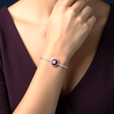 Bracelet with a central gemstone on a person's wrist against a dark background