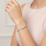 Woman wearing a silver bracelet on a neutral background