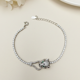 Silver bracelet with a detailed clasp on a light beige surface.