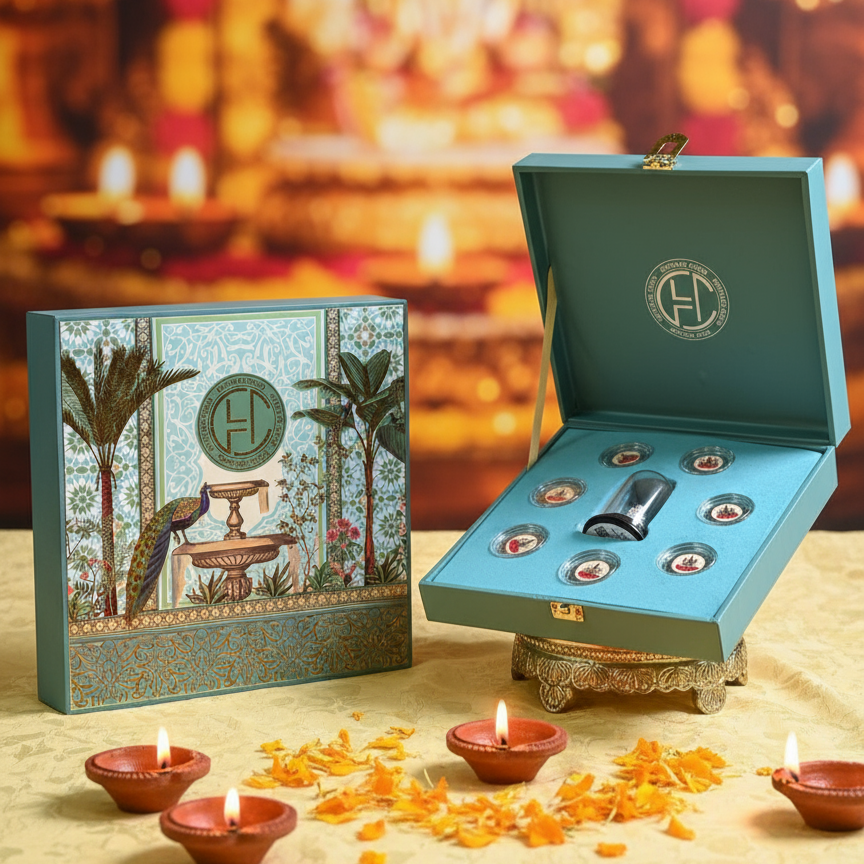 Decorative box with a peacock design on a table with lit candles and Diwali decorations.