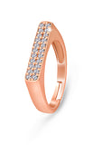A rose gold-colored bar ring with a set of small stones across the top bar, presenting a sparkling and elegant appearance.