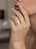 Close-up of a hand wearing a diamond ring with a blurred background