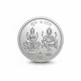 Silver coin with laxmi ganesh deities on a white background