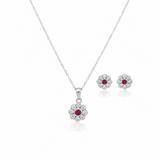 Silver jewelry set with flower-shaped pendants on a white background