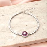 925 Silver bracelet with a red gemstone on a beige surface